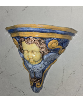 Le village de 58 brocanteurs - Console murale en céramique émaillée à décor de putto